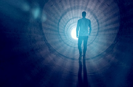 Man walking through the tunnel of light